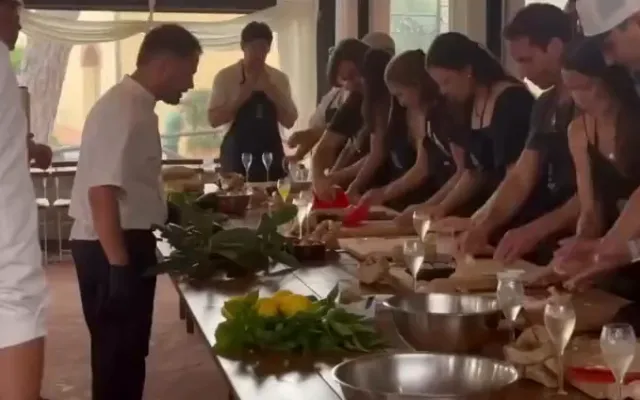Guests making fresh pasta together in an agriturismo kitchen in the hills outside Florence