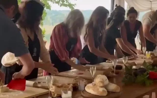 A long table laid for a Tuscan Sunday lunch of fresh handmade pasta