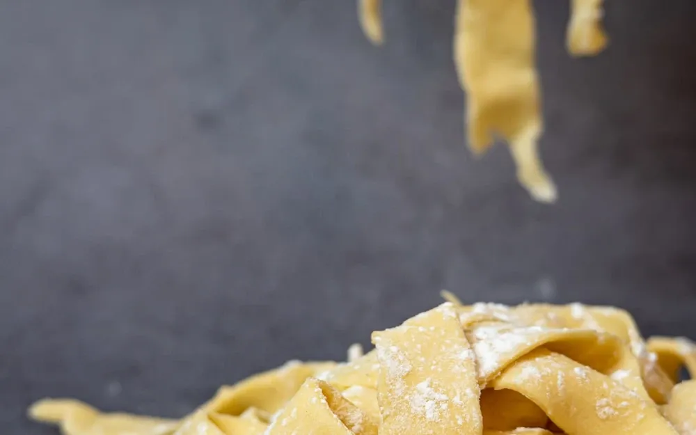 Broad ribbons of fresh egg pappardelle, hand-cut and dusted with flour