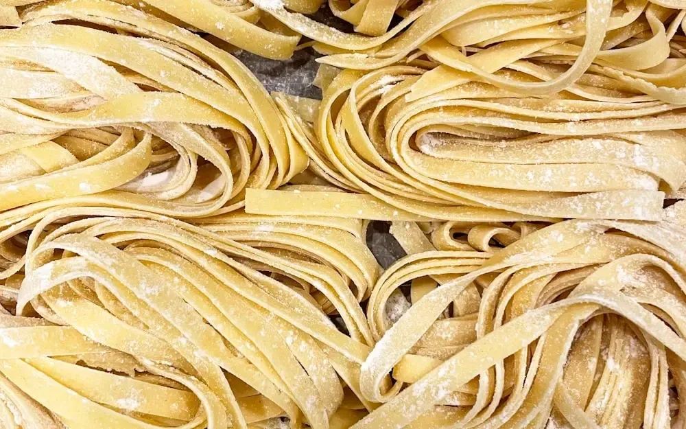 Loose nests of golden egg tagliatelle, rolled thin and cut by hand