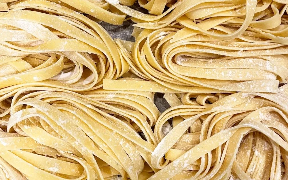 Loose nests of golden egg tagliatelle, rolled thin and cut by hand